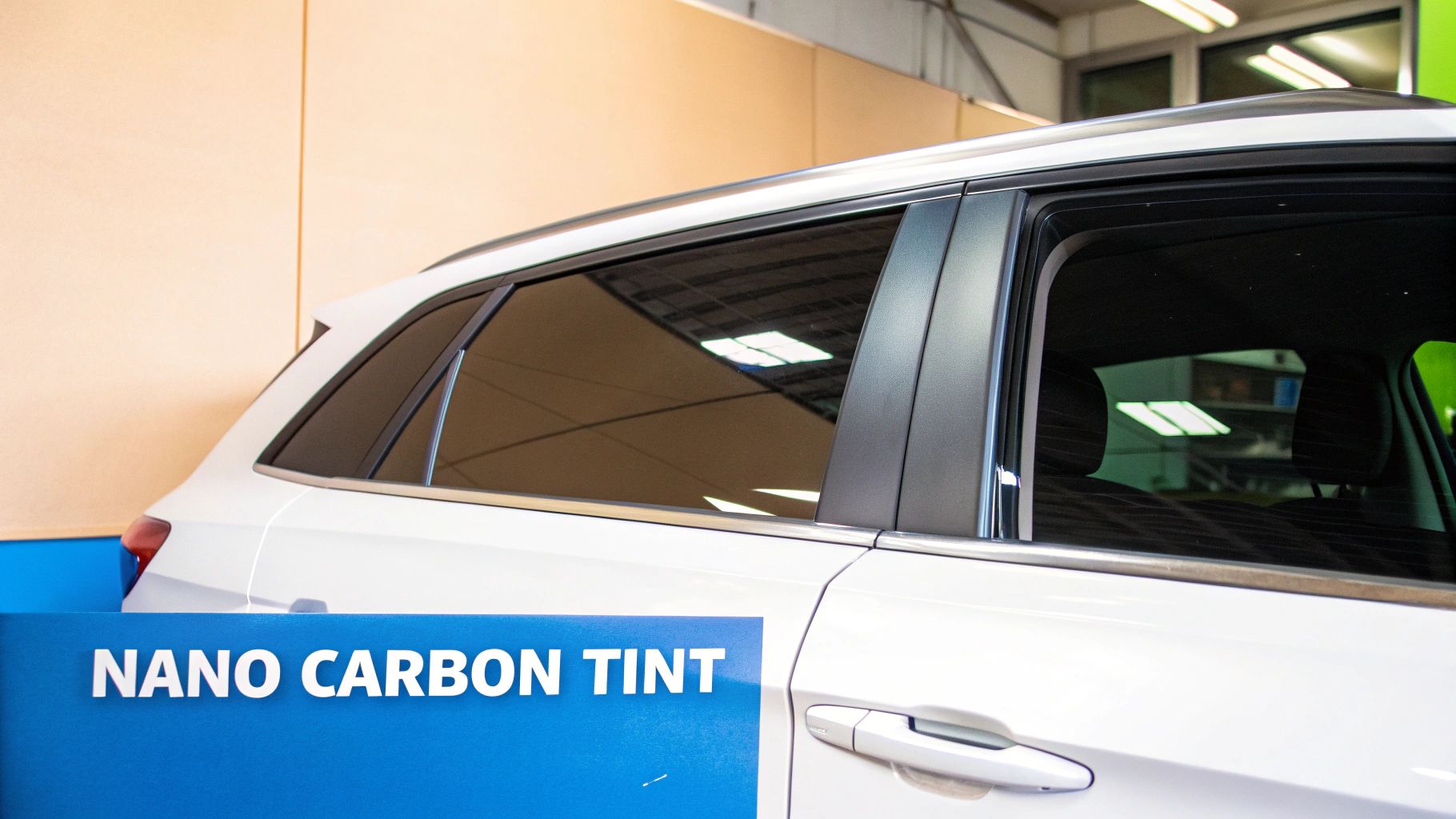 Side view of a white car showcasing dark nano carbon window tint on its rear and passenger windows.