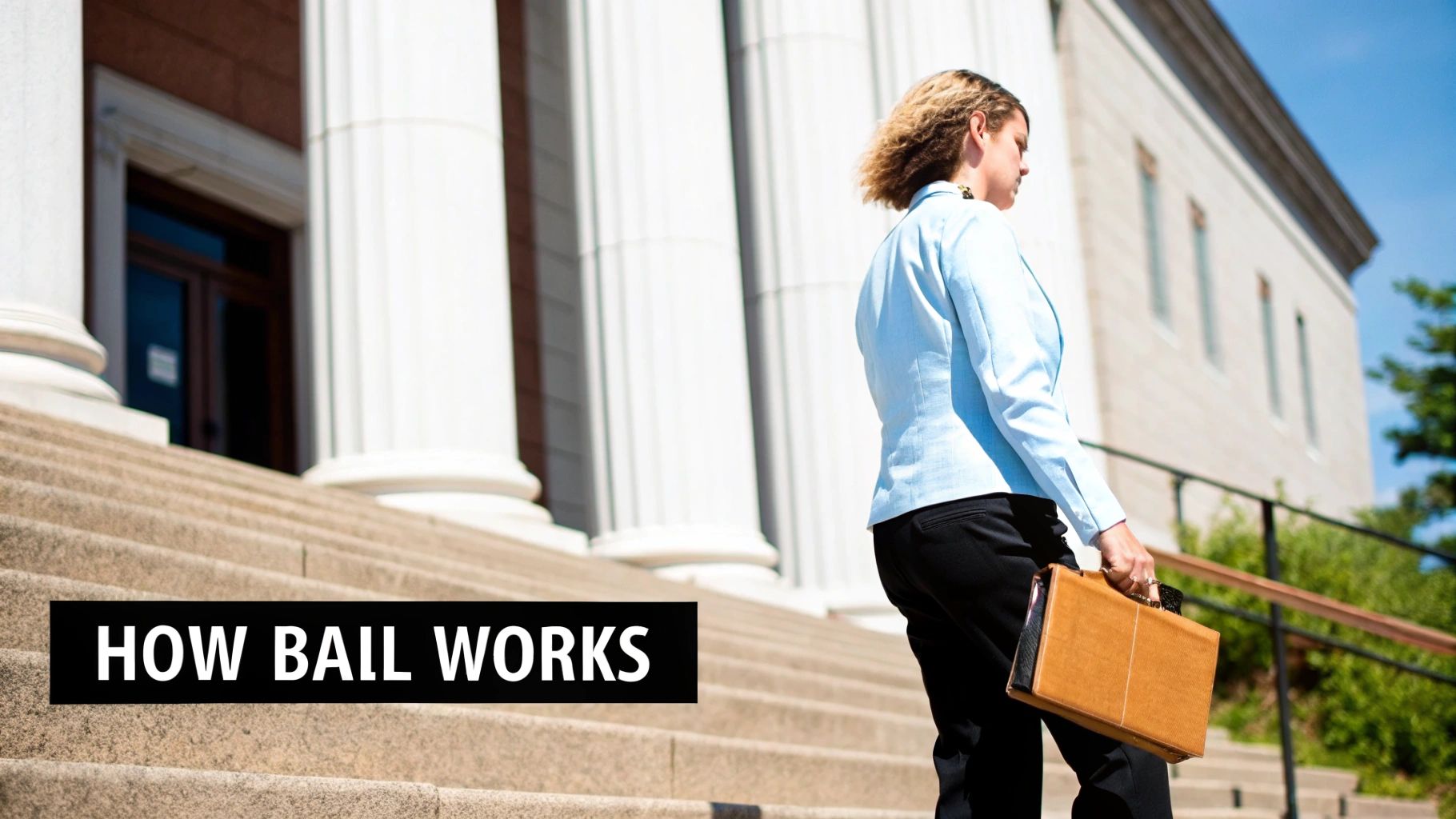A professional woman with a briefcase walks up the grand steps of a courthouse on a sunny day.