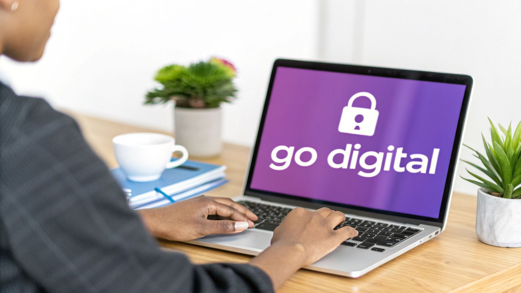 Professional woman using laptop displaying go digital with security lock icon on purple screen