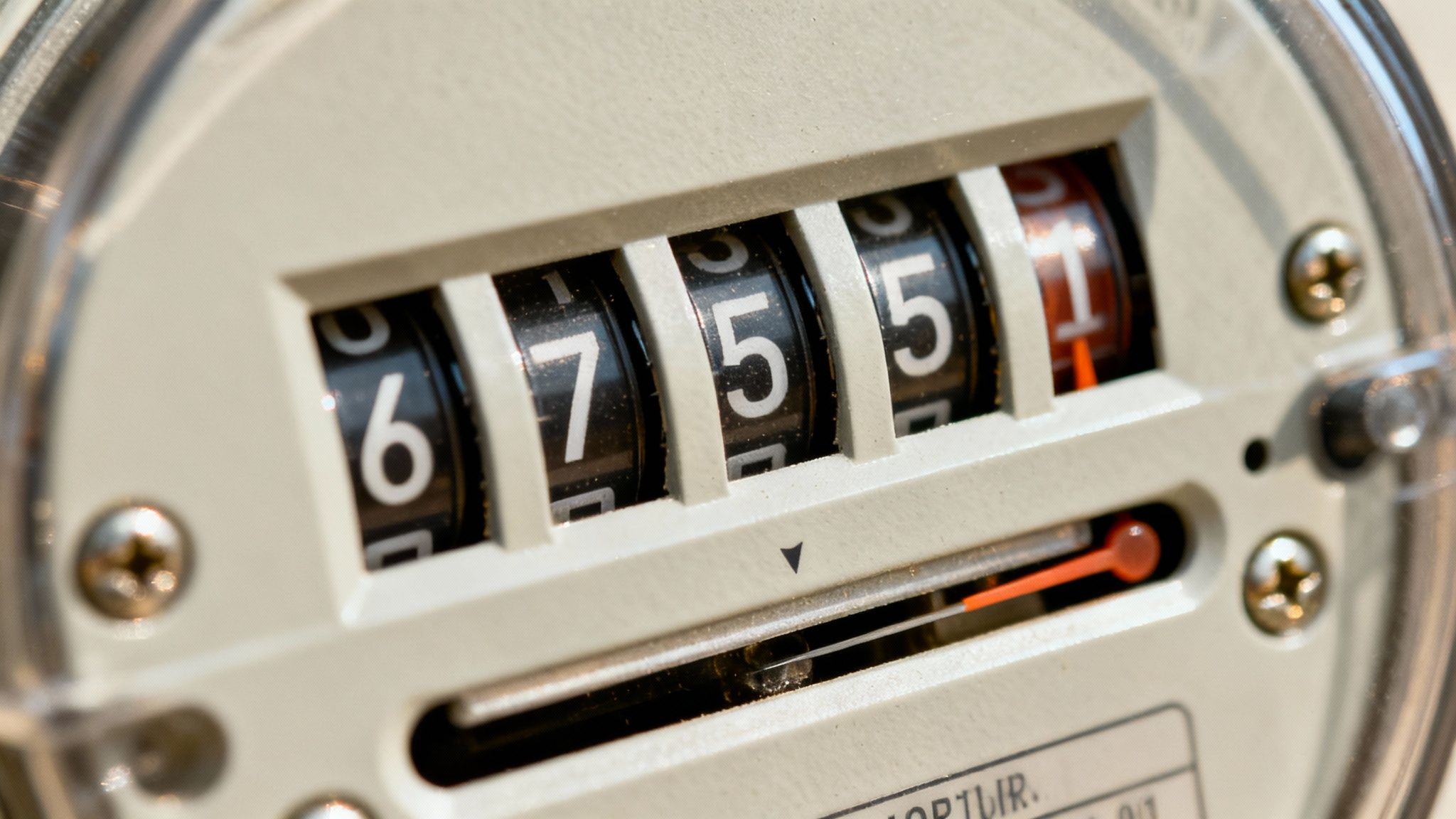A traditional analog electric meter with multiple dials.