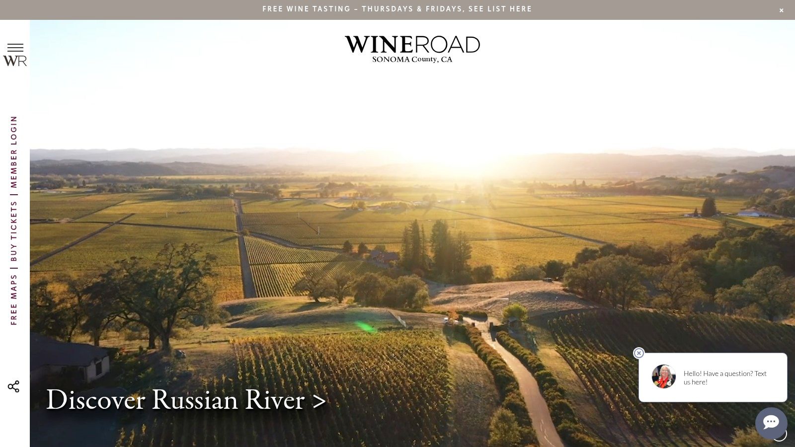 A scenic view of a Sonoma County vineyard landscape, highlighting the rolling hills and lush vines that characterize the region.