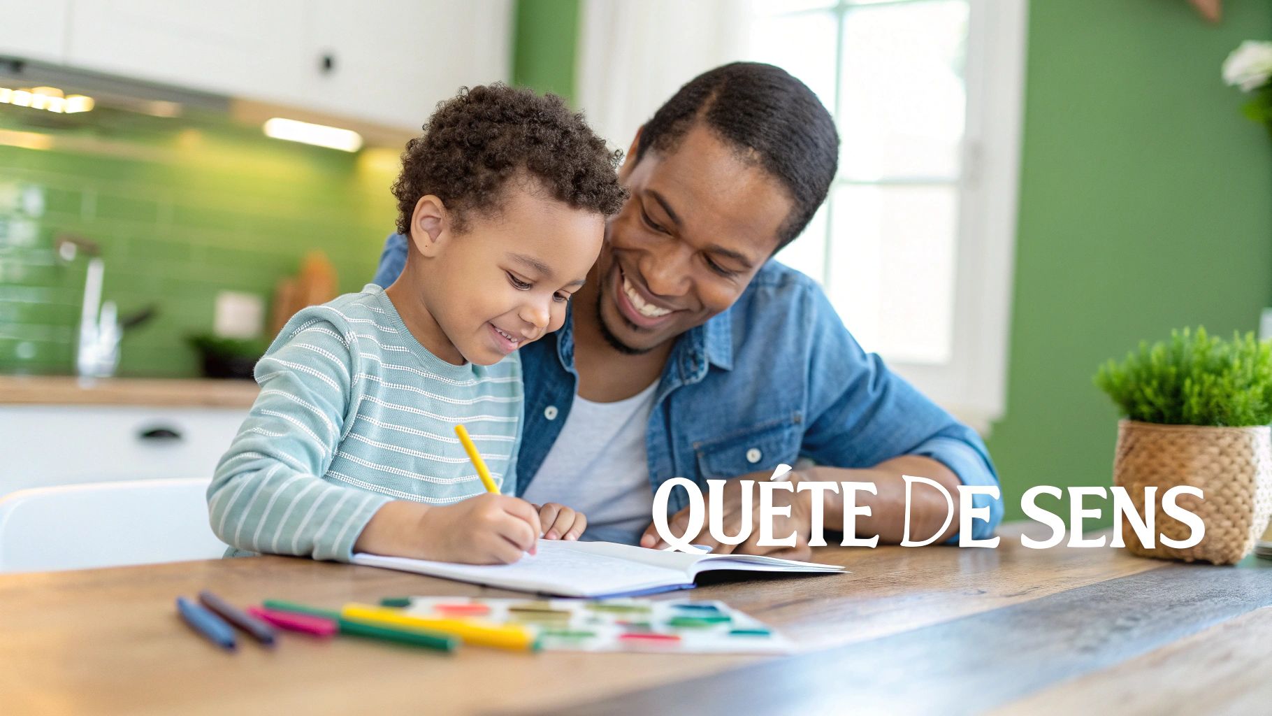 A smiling father and his young son are drawing together at the table, surrounded by colored pencils.
