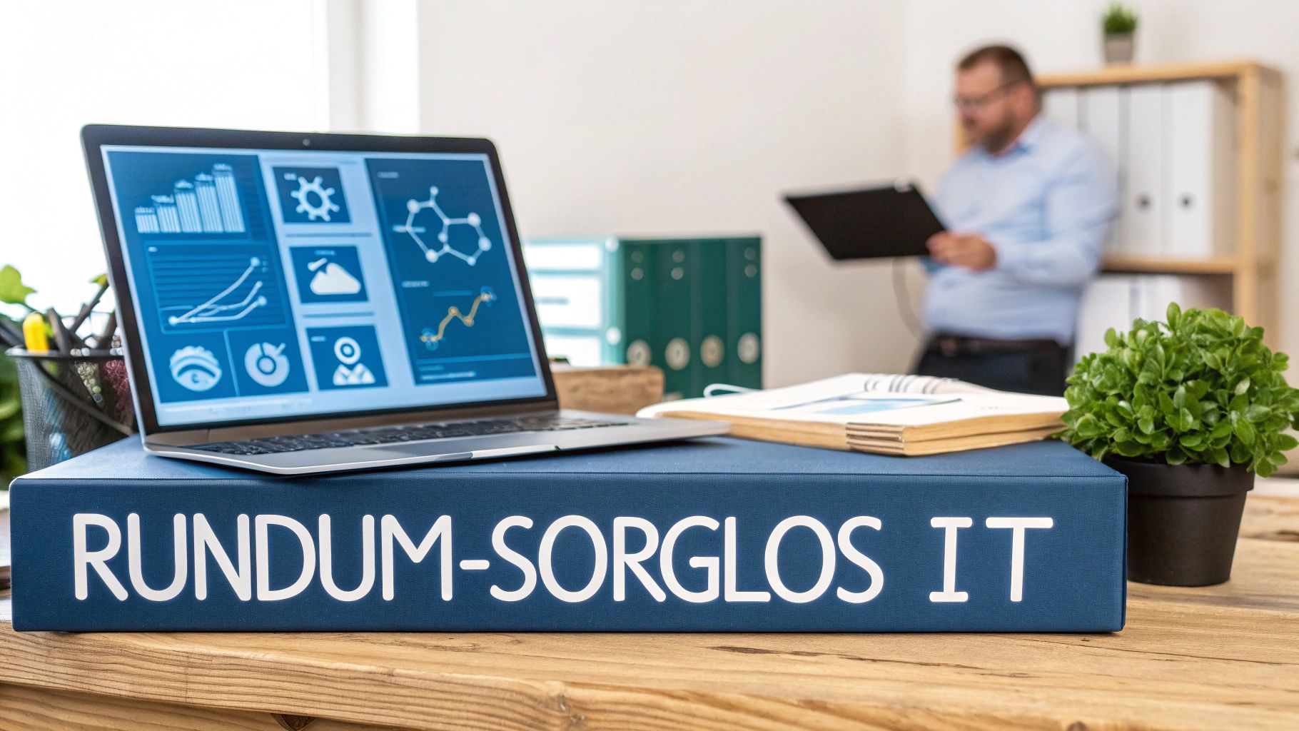 Büroansicht mit Laptop, der IT-Daten anzeigt, und einer prominenten Box 'RUNDUM-SORGLOS IT' auf dem Schreibtisch.