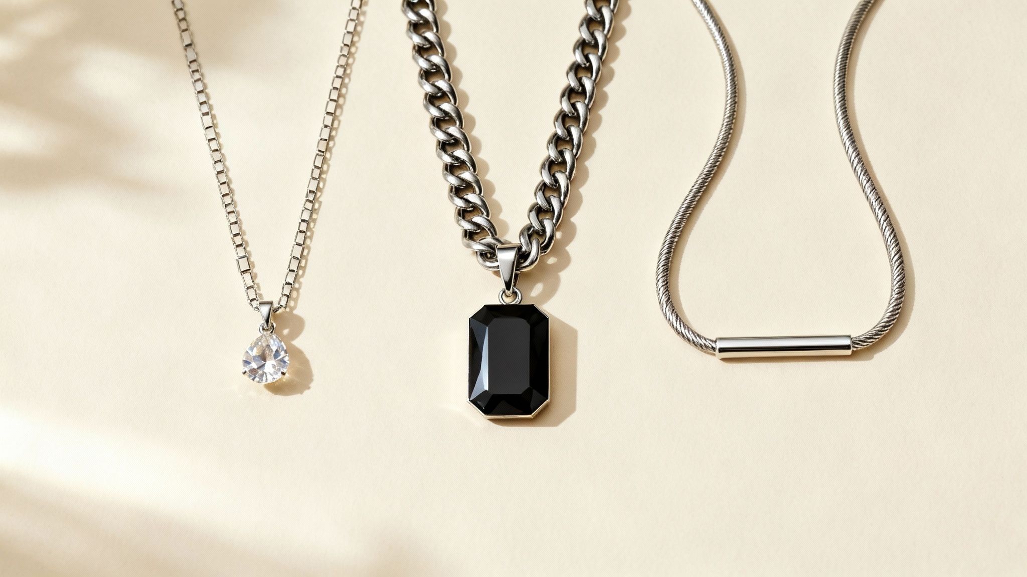 A woman layering different necklace chains types with pendants