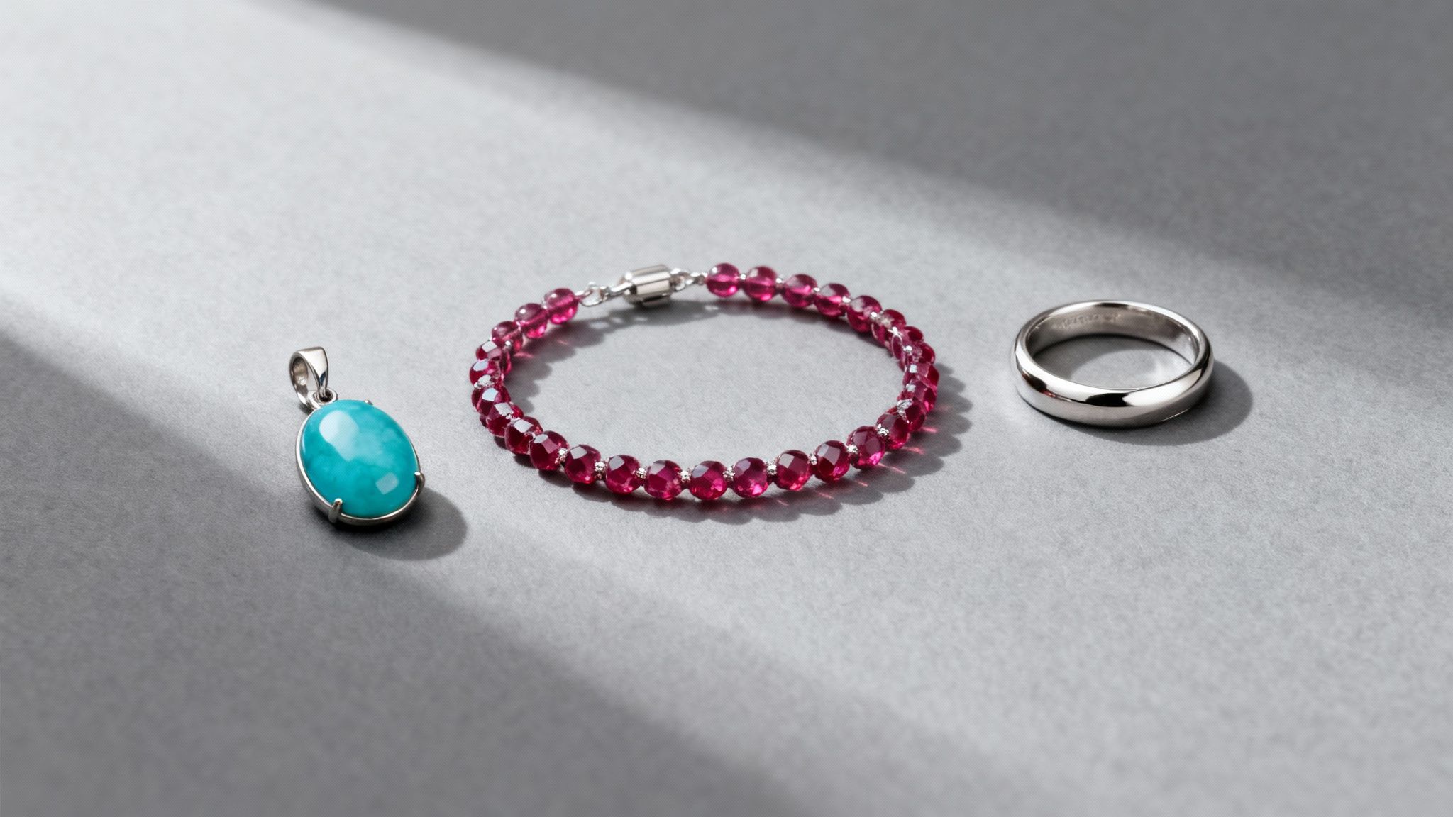 A close-up of a silver anniversary ring with intricate details, resting on a reflective surface.