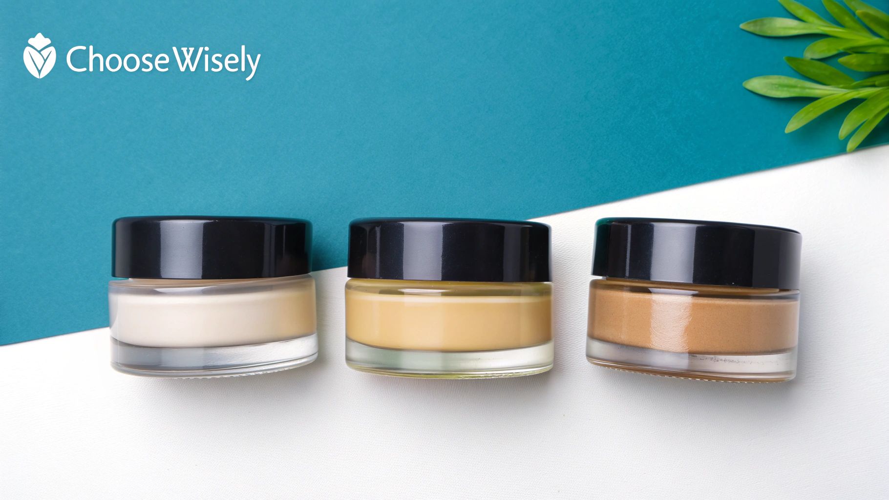 Several bottles of lotion-making supplies and ingredients arranged on a white surface.