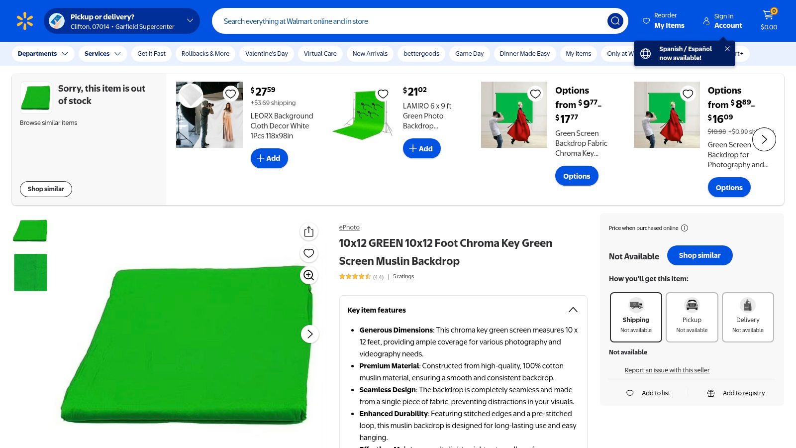 A person holding a green screen backdrop purchased from Walmart, showcasing its size and fabric.