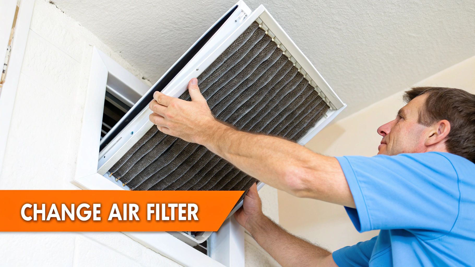 A man in a blue shirt is replacing a dirty air filter in a home's ceiling vent.