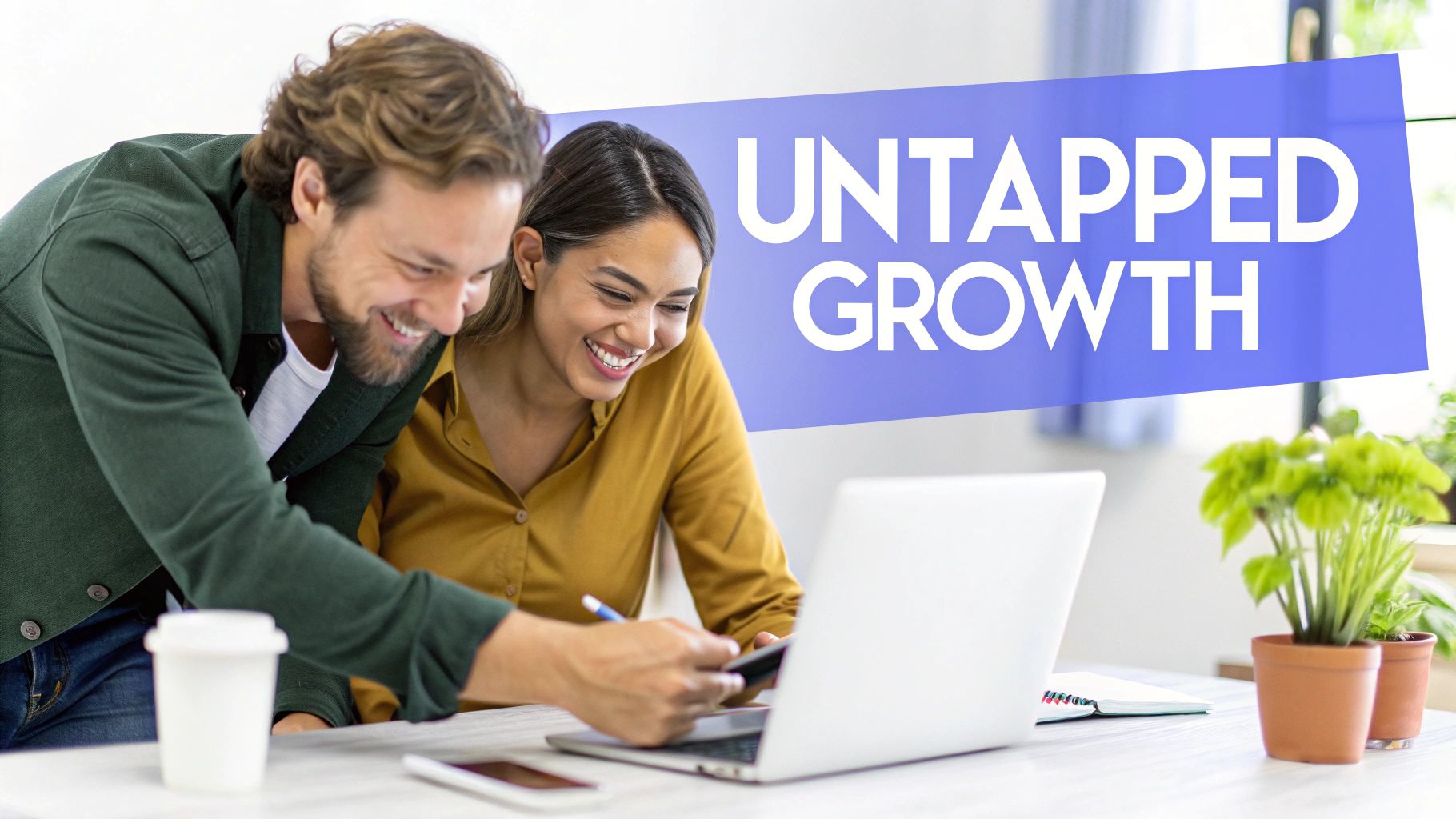 Two smiling business professionals, a man and a woman, collaborating on a laptop with text 
