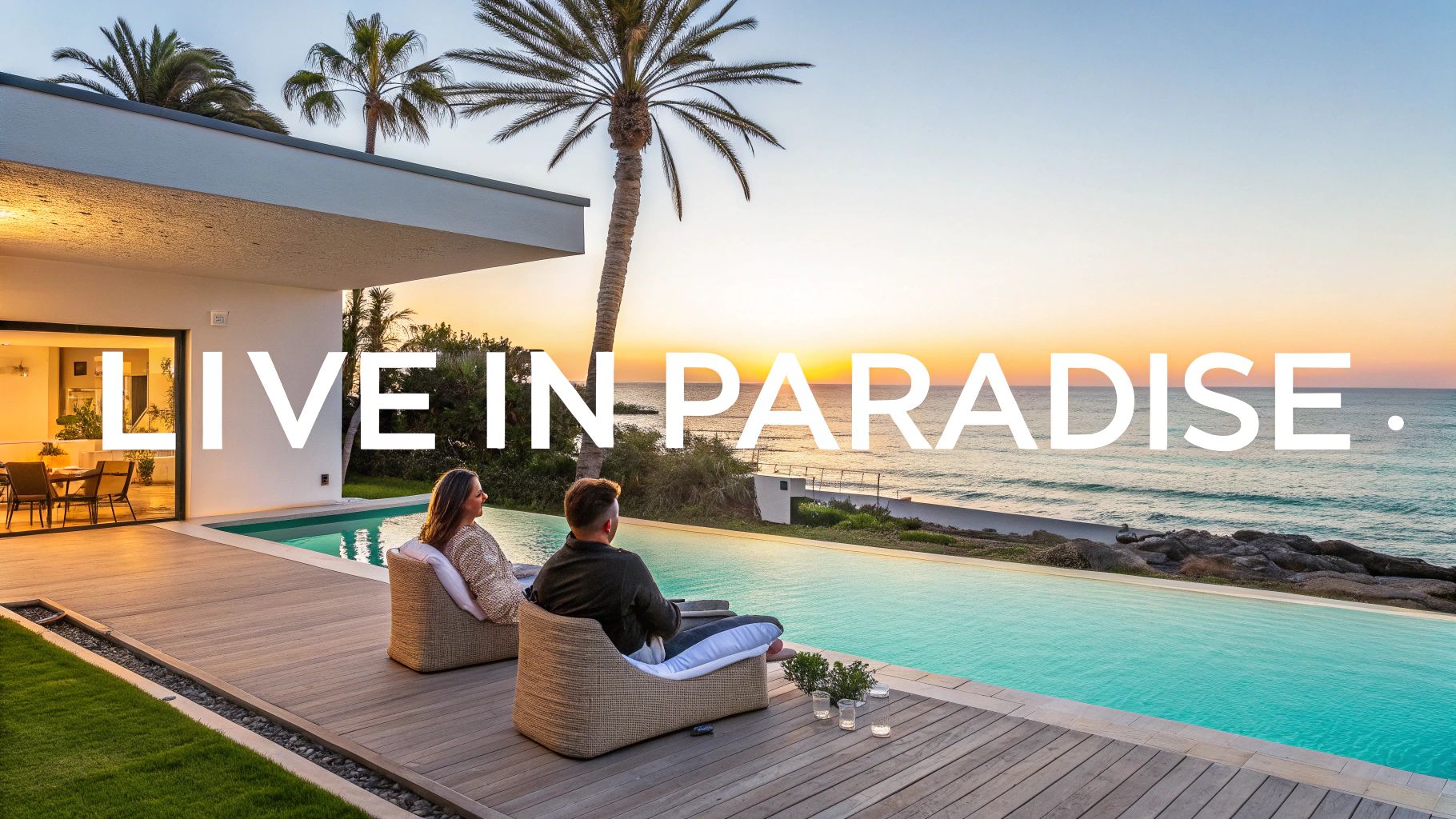 Una pareja relajándose junto a una piscina infinita con vista al mar al atardecer, simbolizando una vida de lujo.
