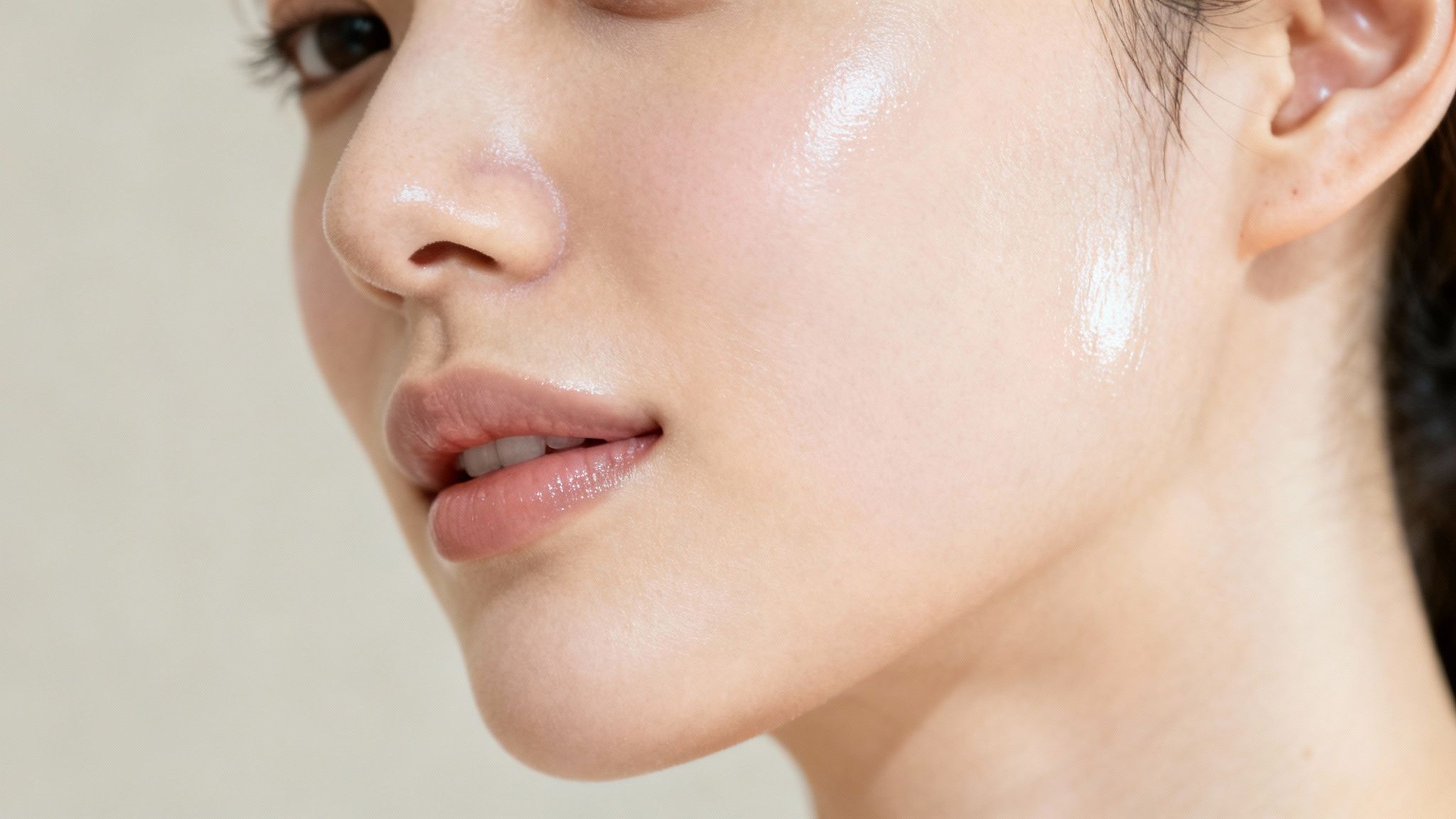 Close-up of a person's flawless, dewy skin, showcasing a radiant and healthy glow.