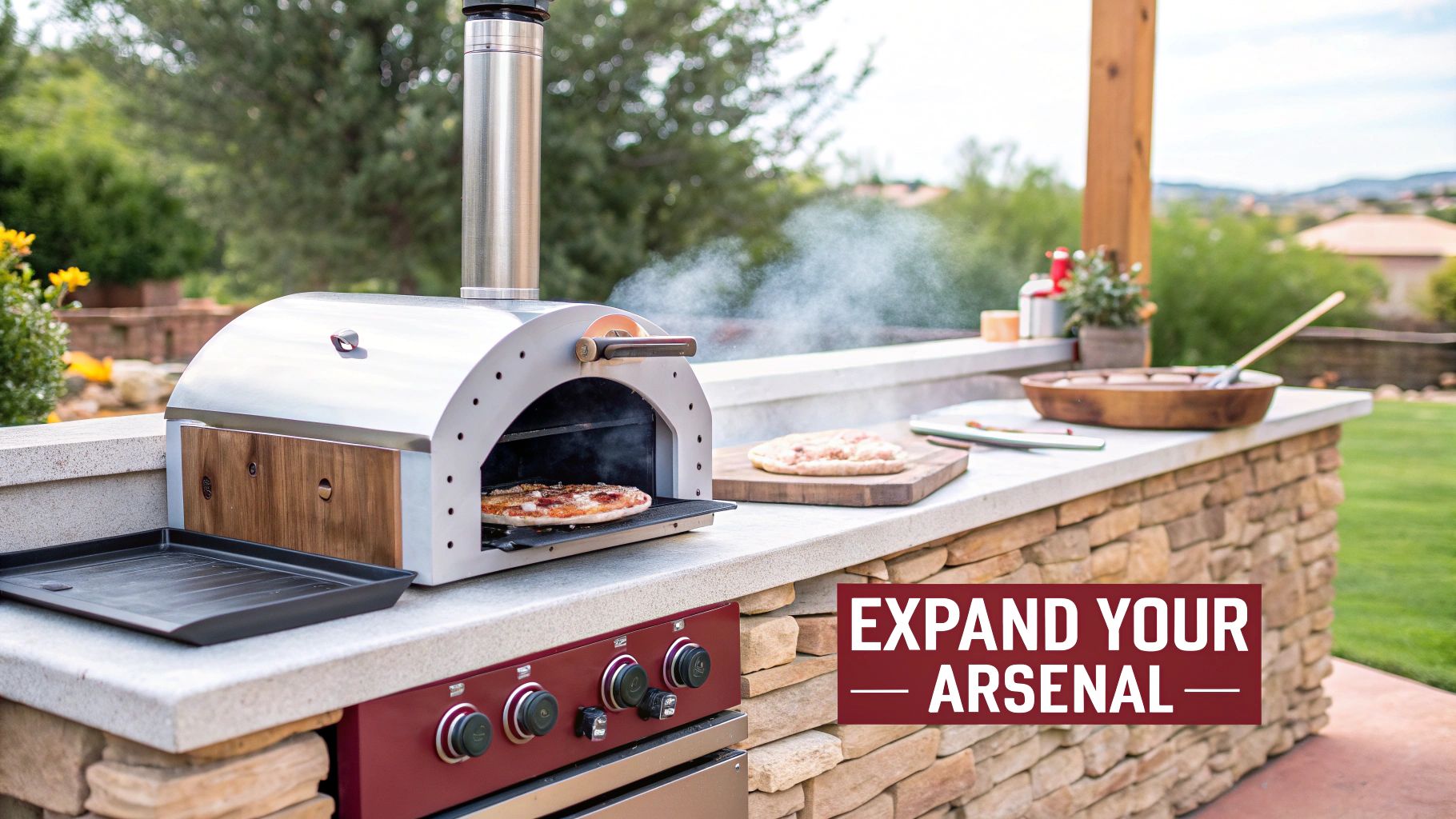 An outdoor stone kitchen features a stainless steel pizza oven with a cooking pizza, and a grill.