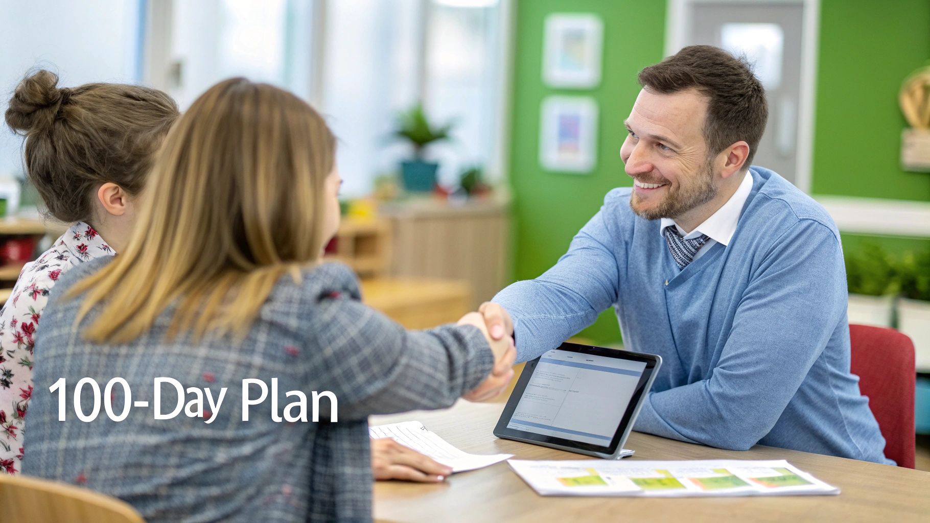 Professional man shaking hands with parent during 100-day plan educational consultation meeting