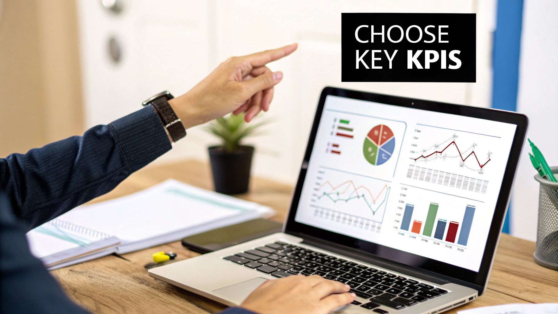 A person pointing at a dashboard with various charts and graphs, representing the selection of important KPIs.