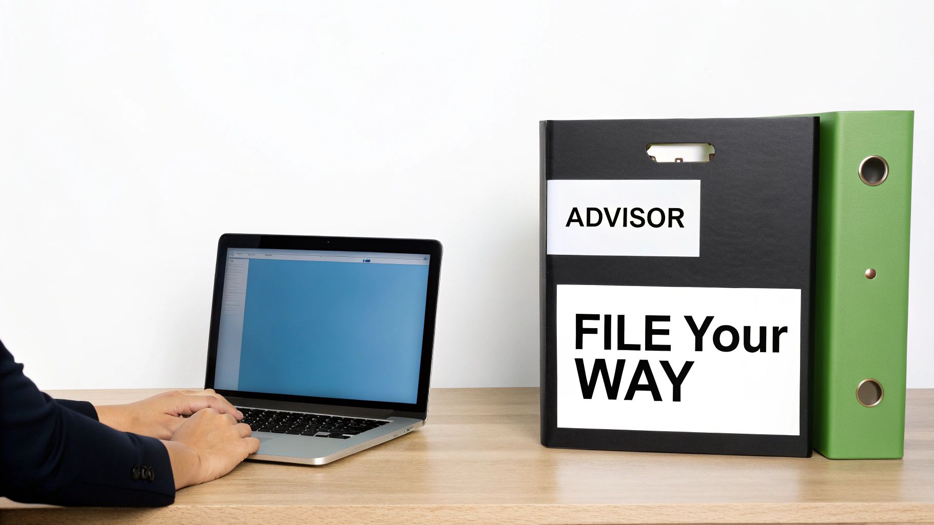 Professional working on laptop with advisor file organizer and binder on desk for tax preparation
