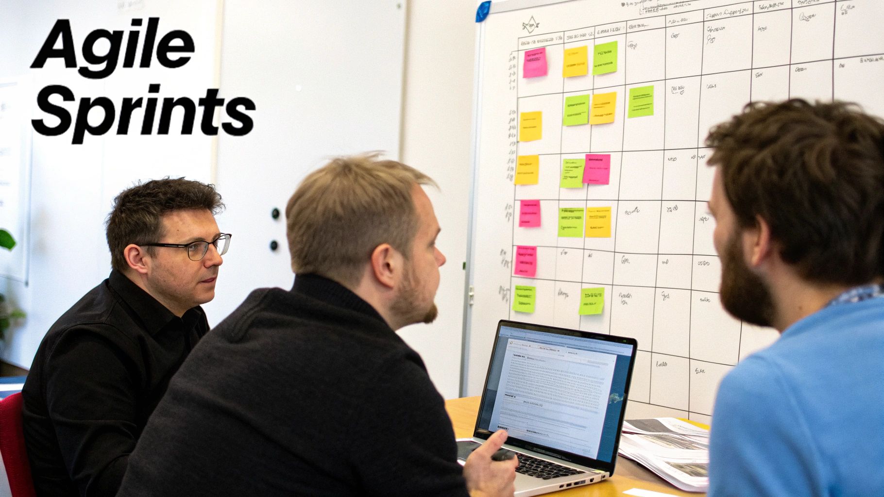 Three men discuss agile sprints, planning tasks on a whiteboard with sticky notes and using a laptop.