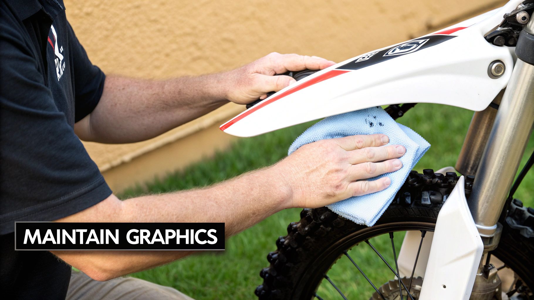 A clean dirt bike with a recently applied sticker kit stands in a garage.