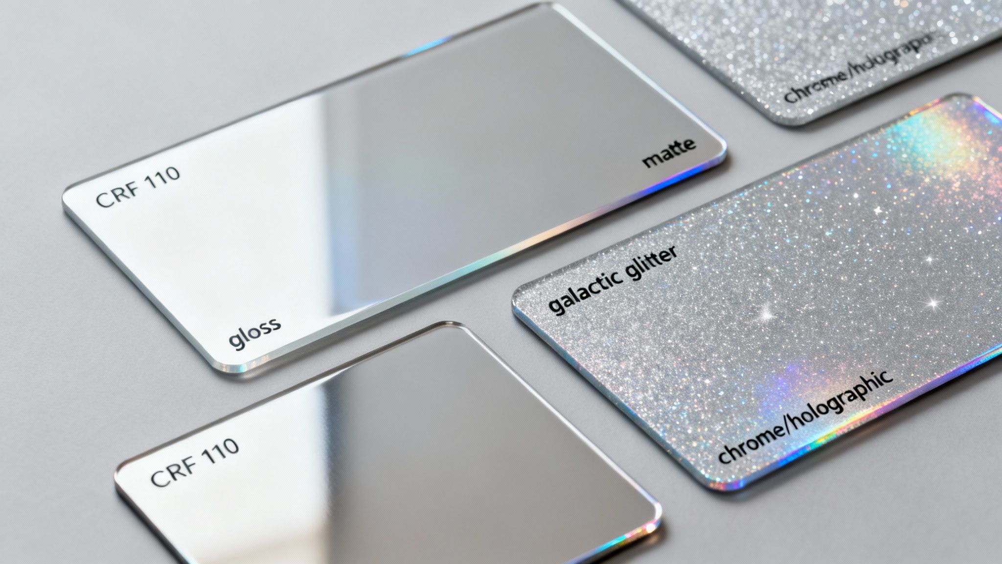 Various CRF 110 graphic finish samples including gloss, matte, galactic glitter, and chrome holographic options