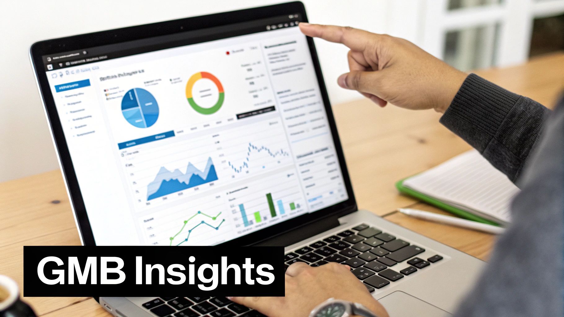 Person's hands on a laptop displaying Google My Business insights with various charts and graphs.