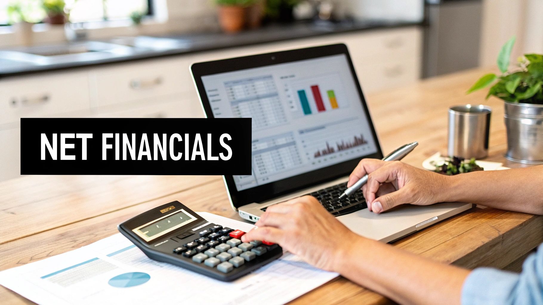 Person calculating net financials with a laptop, calculator, and documents on a wooden desk.