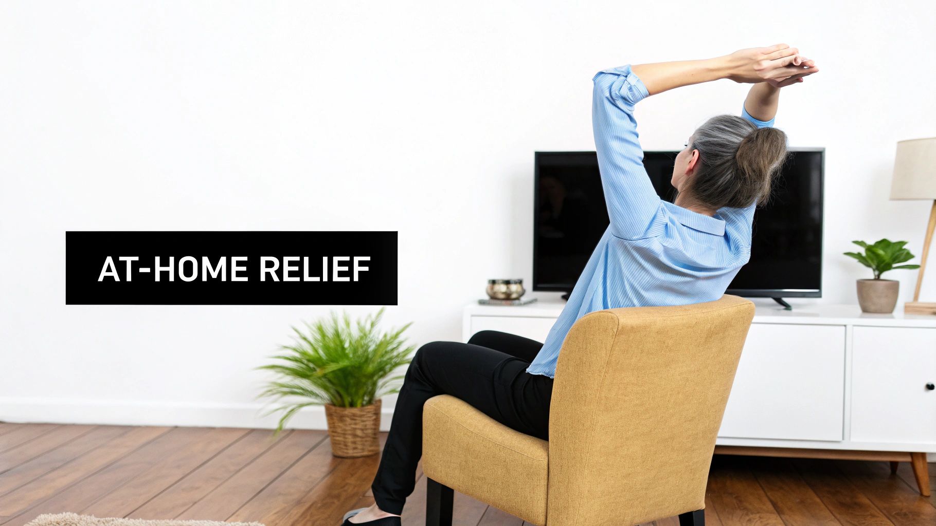 Woman stretching arms overhead while sitting in yellow chair at home for pain relief