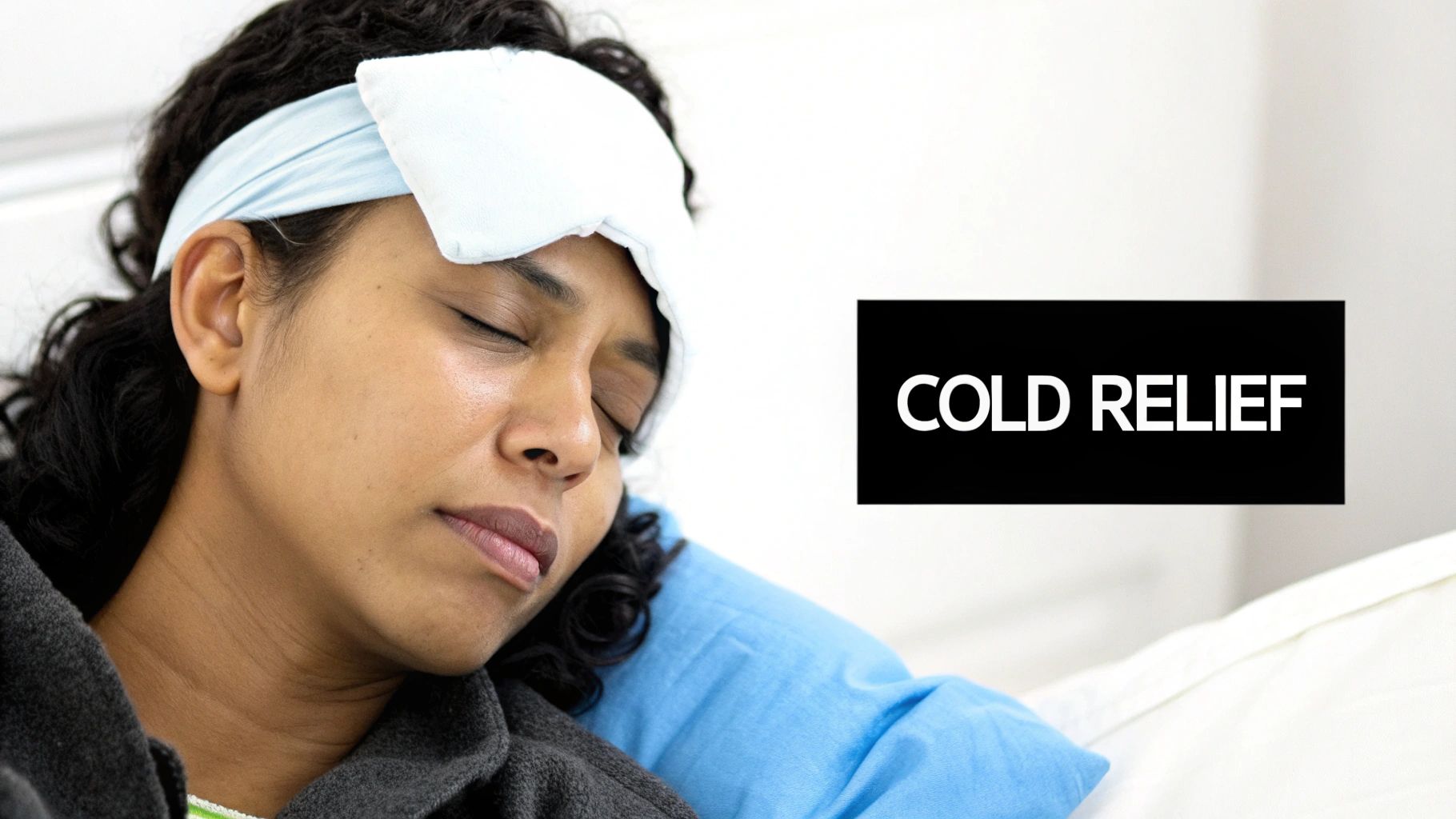 A person with a cold compress on their forehead, resting in bed, seeking cold relief.