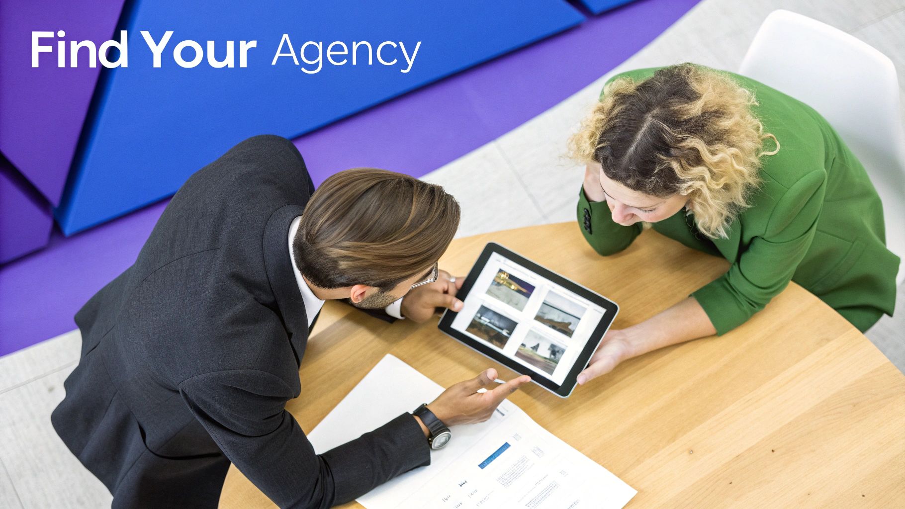 Business professionals discuss project images on a tablet, consulting to "Find Your Agency".