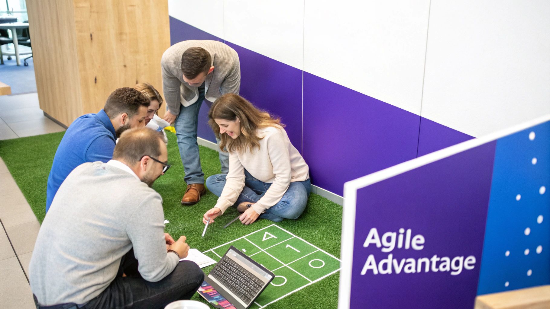 Diverse team members engaged in an interactive agile workshop on a green artificial turf floor.