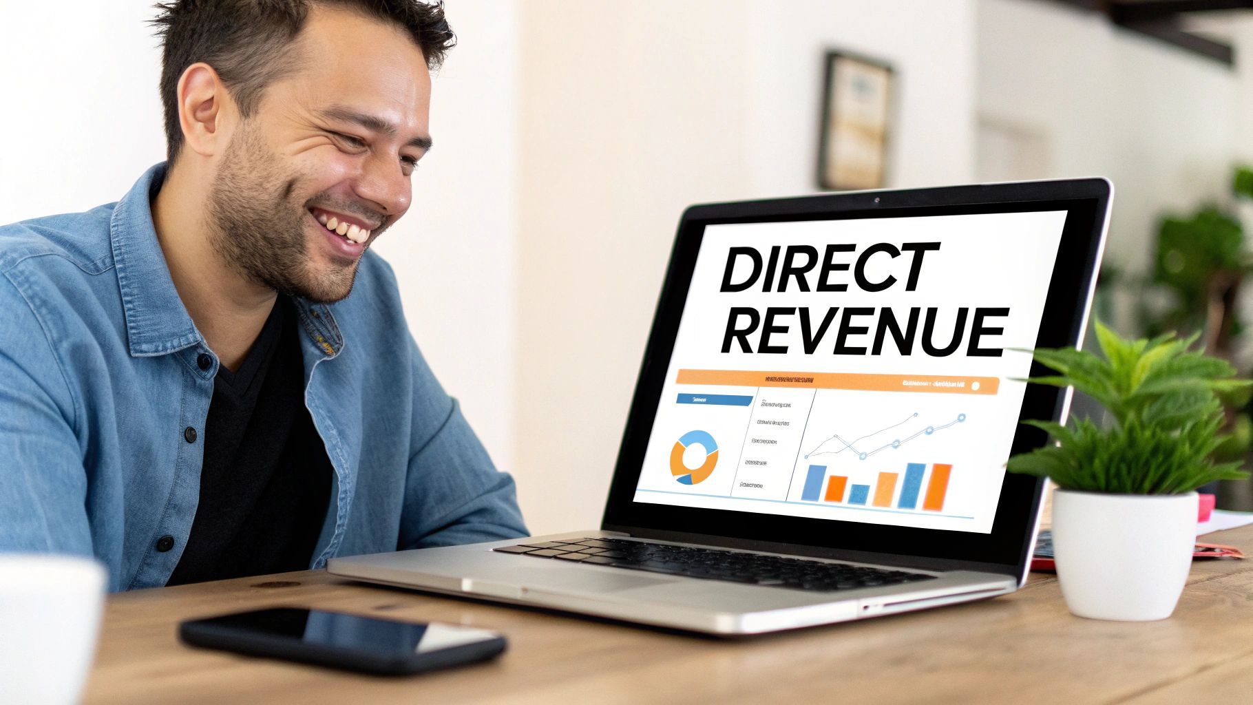 A smiling man views a laptop screen showing 'DIRECT REVENUE' and positive business charts.