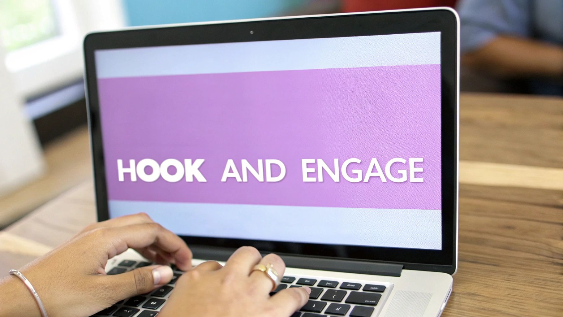 Person typing on a laptop keyboard, screen displays 'HOOK AND ENGAGE' text on a purple background.