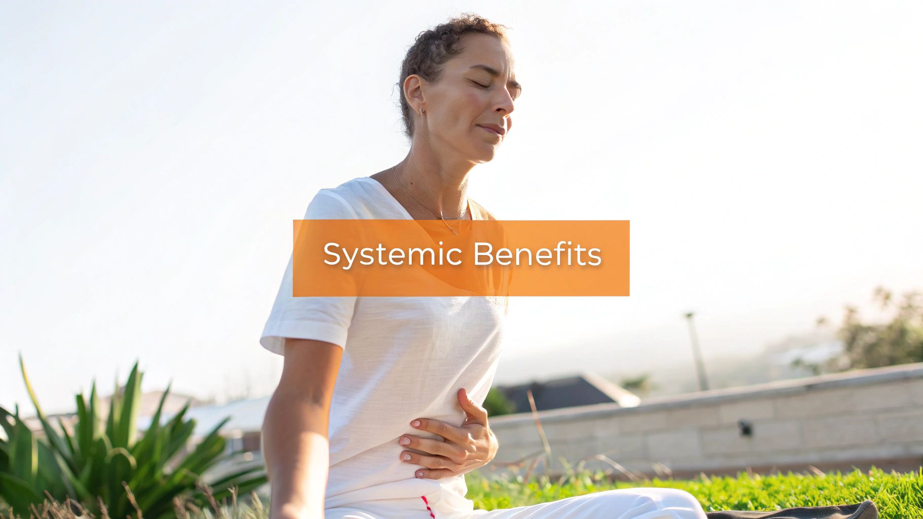 A woman meditating outdoors, holding her abdomen, with the text 'Systemic Benefits' overlaid.