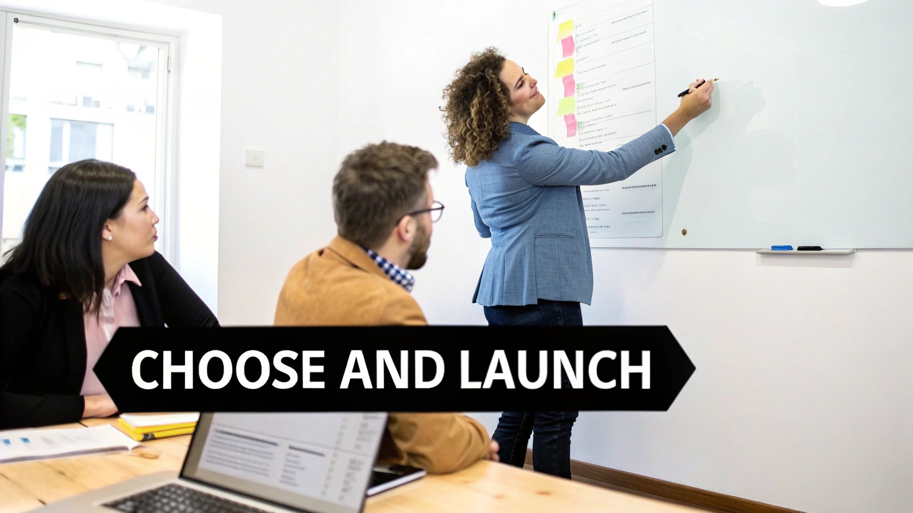 Three colleagues in a modern office collaborating on a whiteboard during a dynamic business meeting.