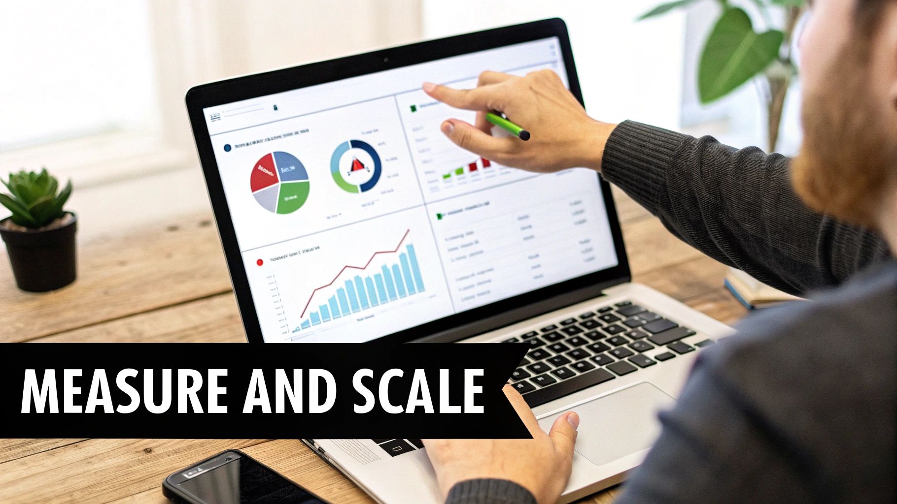 Person analyzing business data on laptop screen with charts, graphs, and 'MEASURE AND SCALE' text.