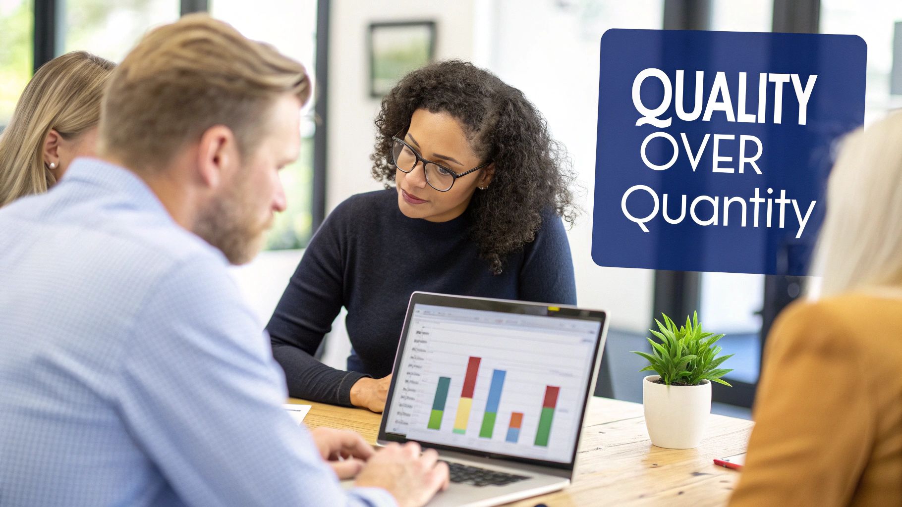 Professionals collaborate around a laptop displaying a bar graph, with a 'Quality Over Quantity' sign.