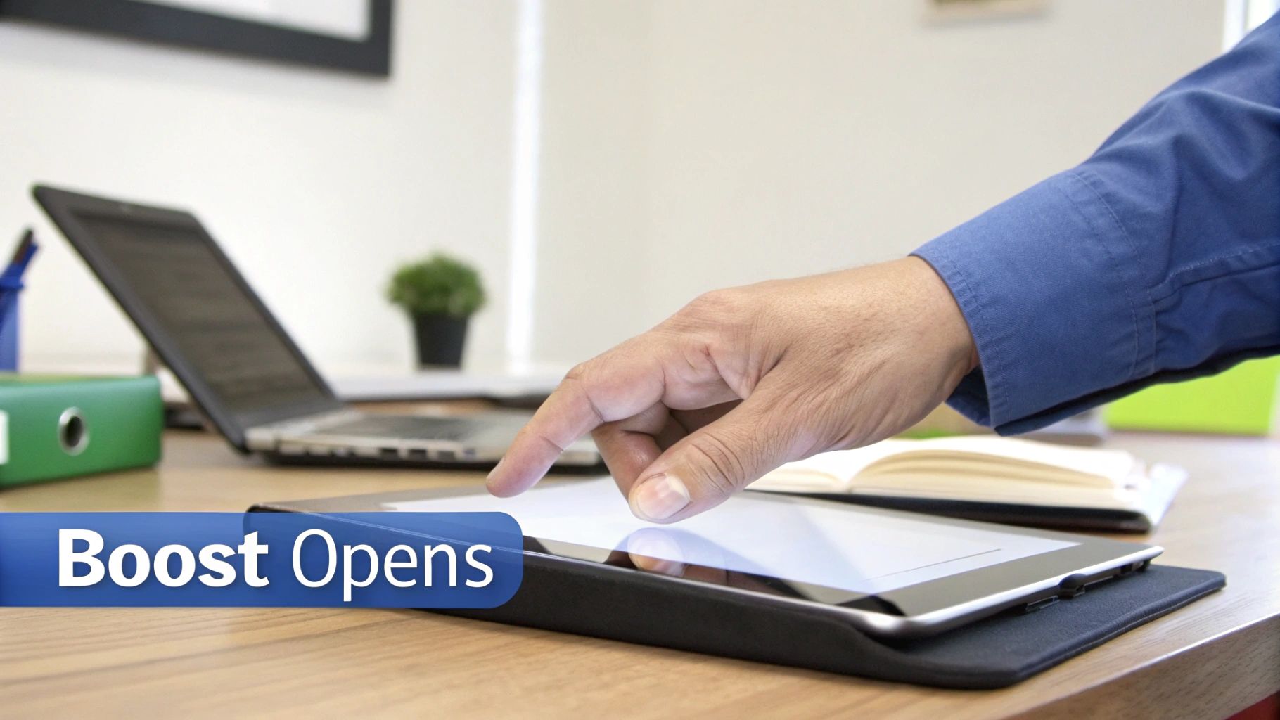 A person's hand taps a tablet on an office desk with a laptop and 'Boost Opens' text for Subject line best practices