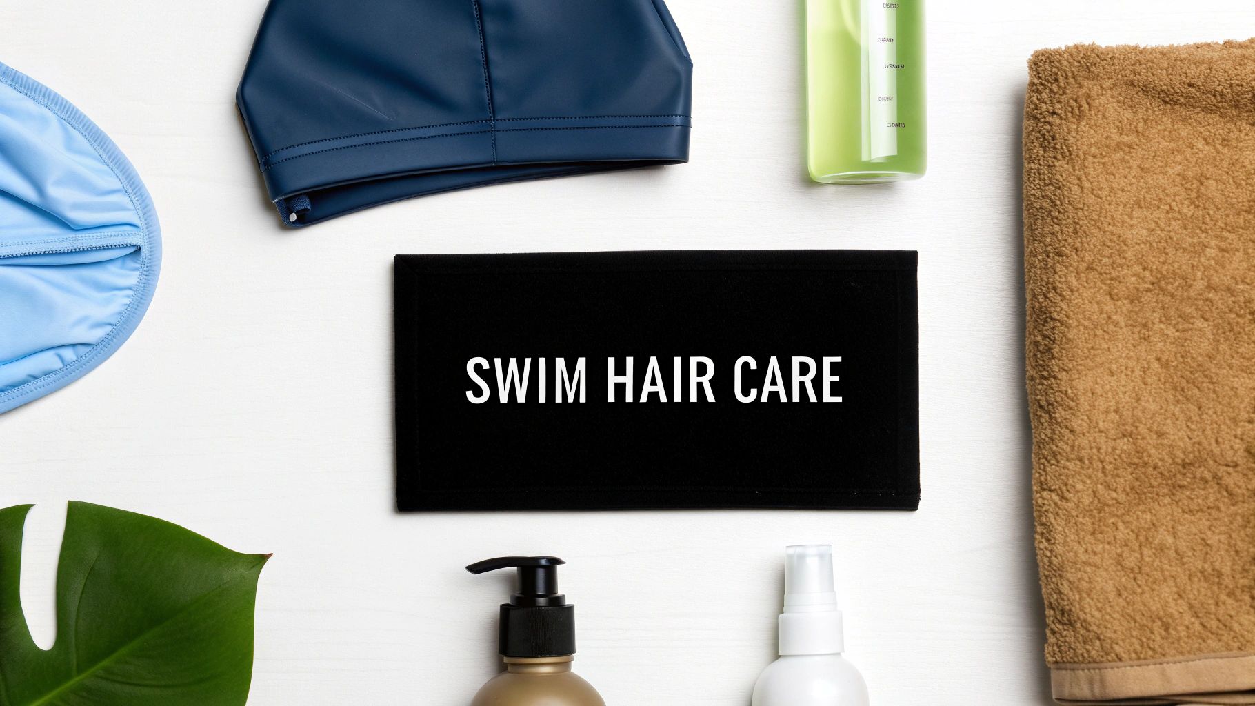 Flat lay with swim caps, hair care products, and a towel around a "SWIM HAIR CARE" sign.