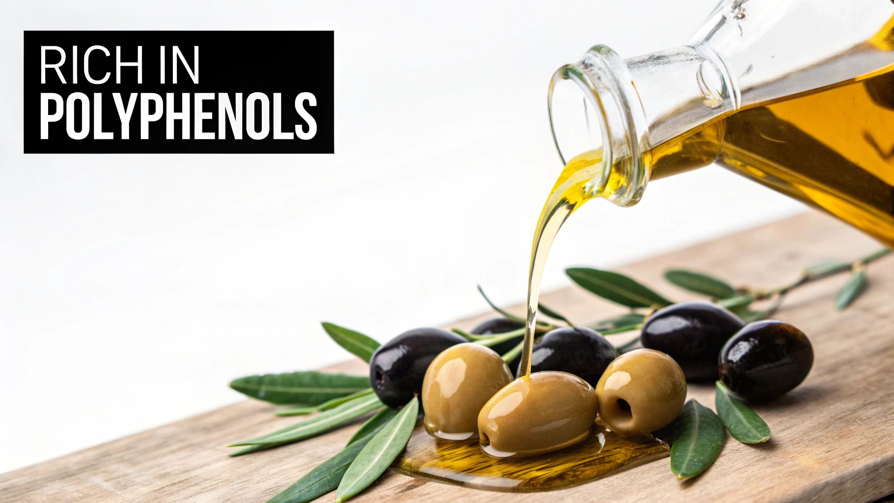 Golden olive oil pours from a glass bottle onto fresh green and black olives on a wooden board.