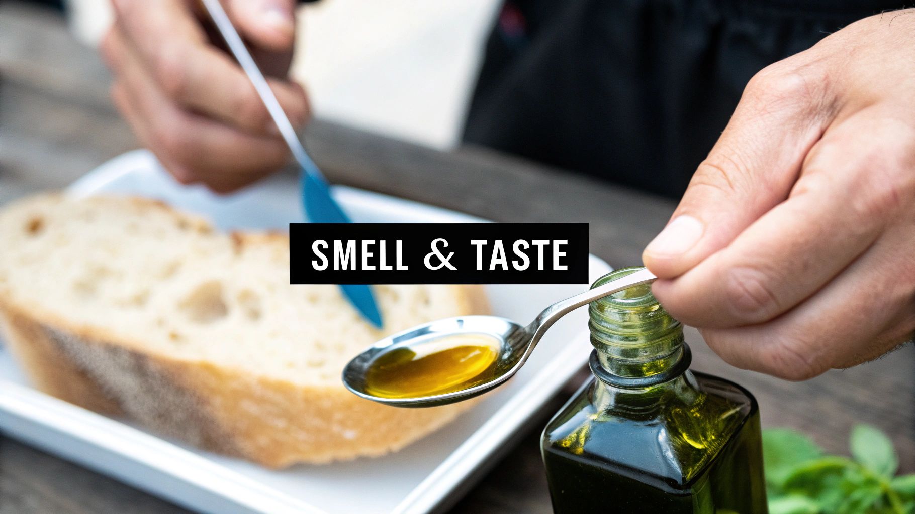 A person pouring olive oil into a small tasting cup, preparing to smell it.