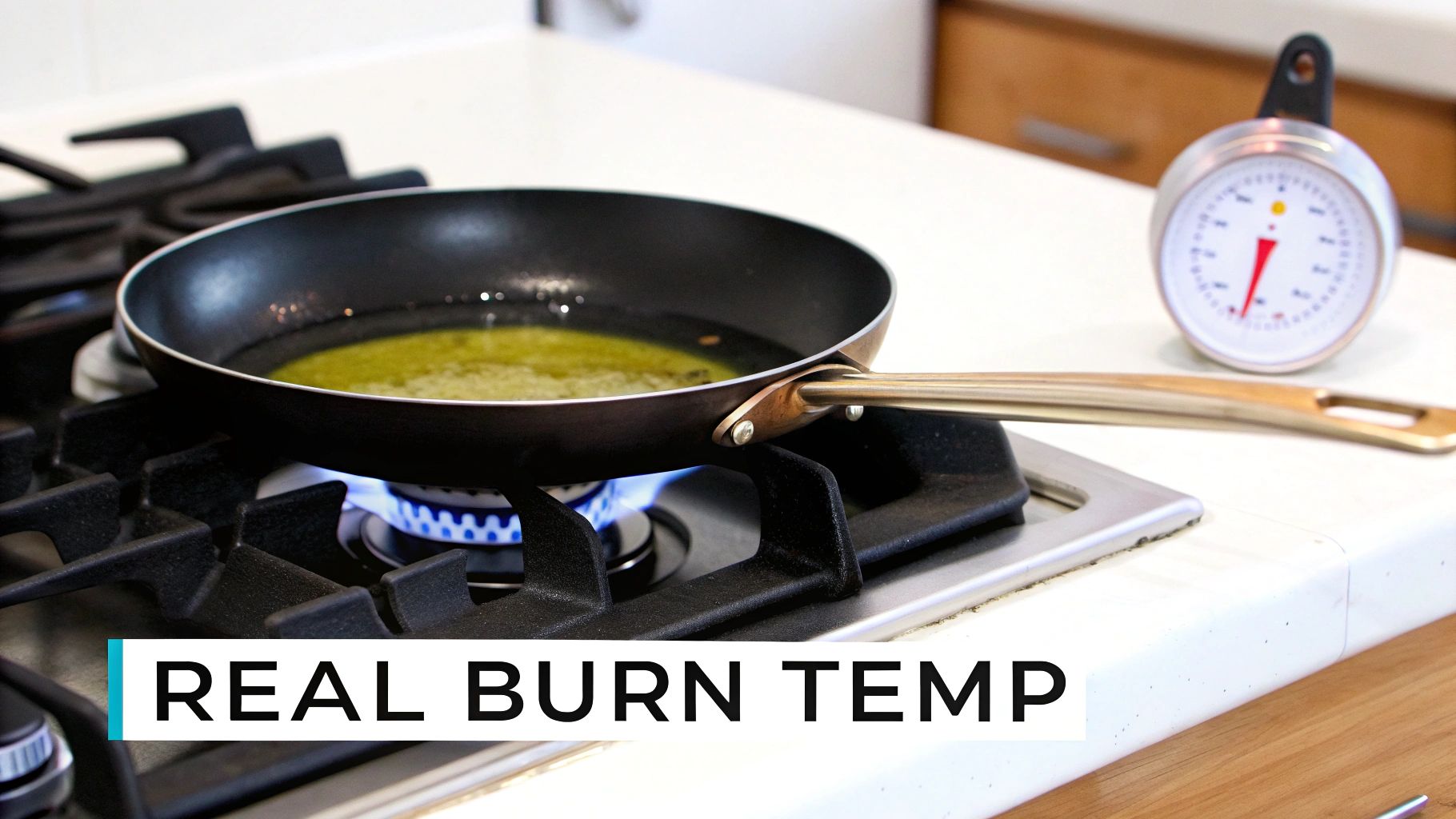 A pan of olive oil heating on a gas stove with a kitchen thermometer on the counter.