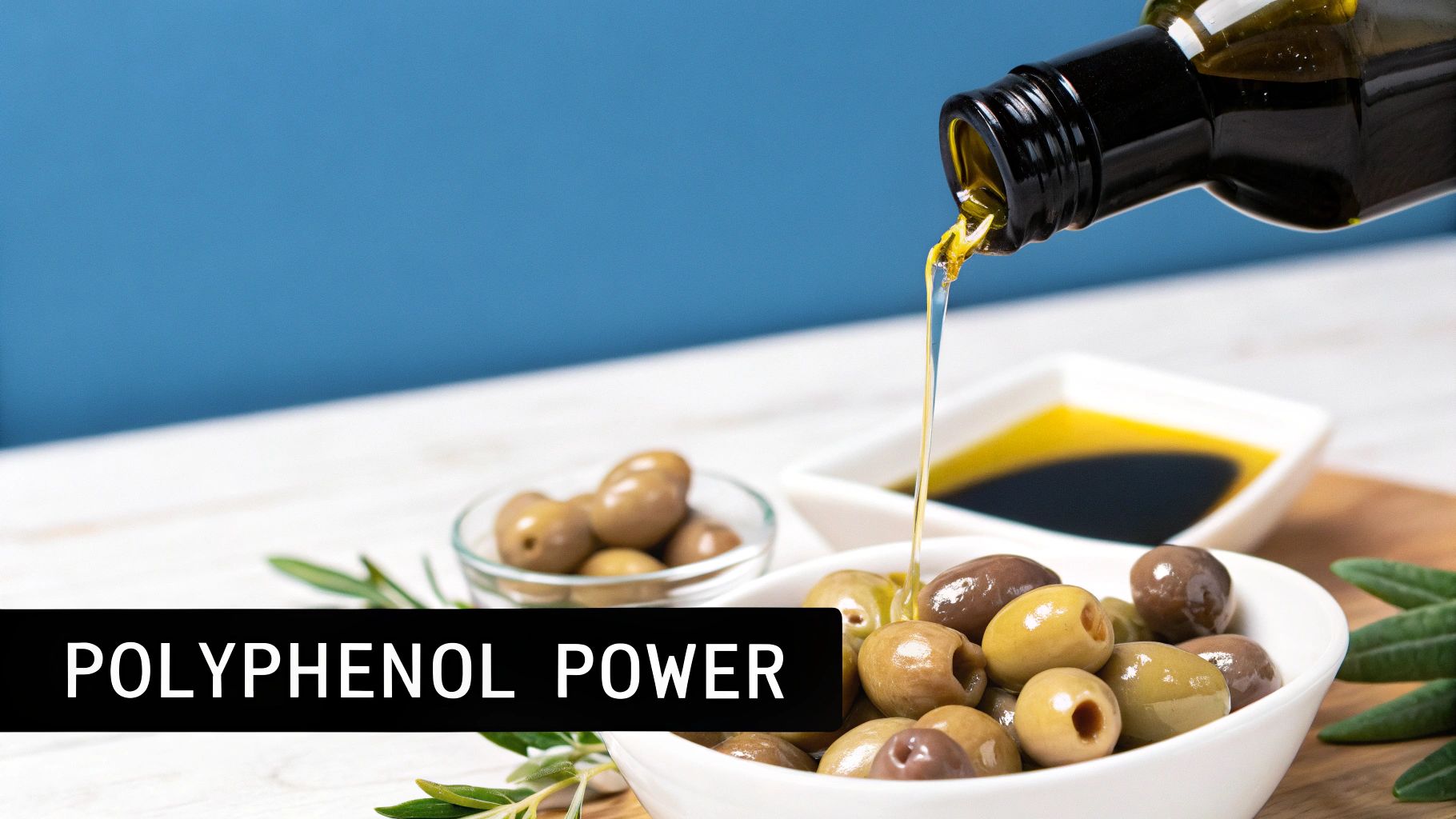 A bottle of extra virgin olive oil surrounded by fresh green olives