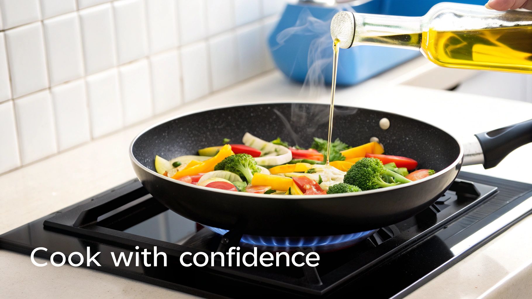 A hand pours olive oil from a clear bottle into a black frying pan filled with colorful vegetables, cooking on a gas stove.