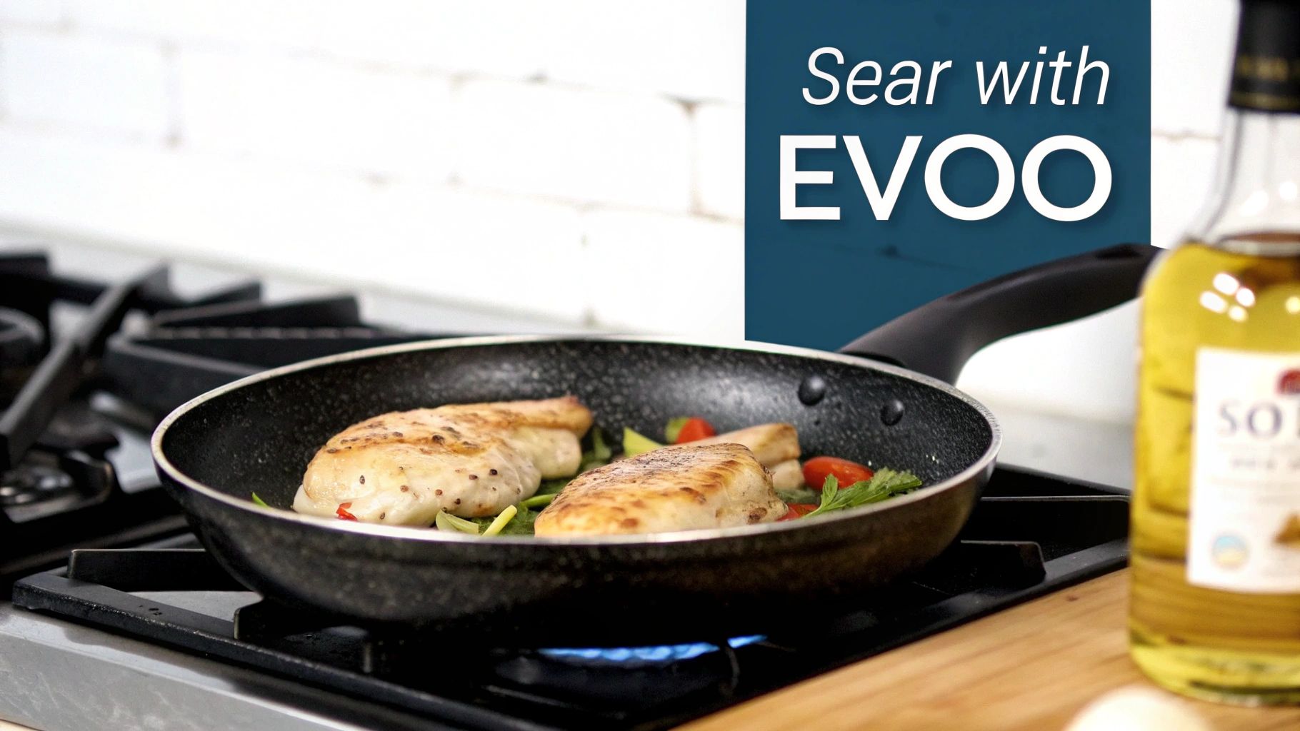 A hand holding an olive branch with green olives, with a blurred background of an olive grove.