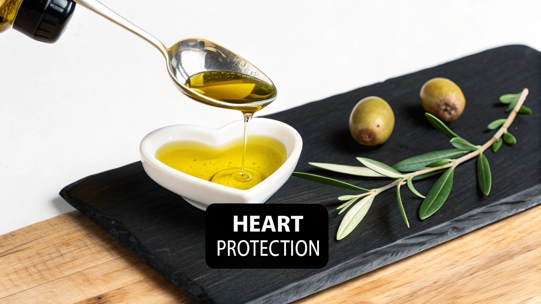 Olive oil being poured into heart-shaped bowl with olives and leaves promoting heart health protection