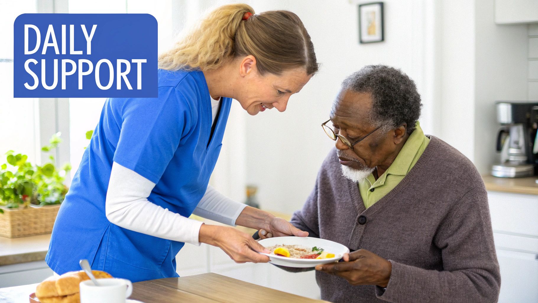 A compassionate caregiver in blue scrubs serves a meal to an elderly Black man at a table.