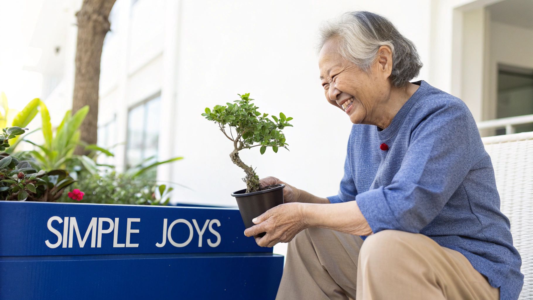 Smiling elderly Asian woman joyfully holds a small potted plant near a 'SIMPLE JOYS' planter.
