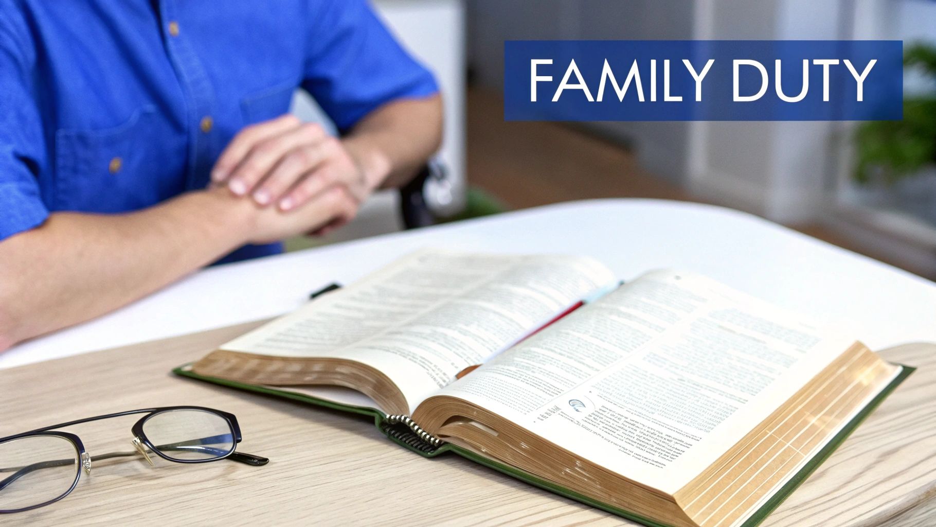 A person with an open book on a wooden table, featuring a blue banner with the text 'FAMILY DUTY'.