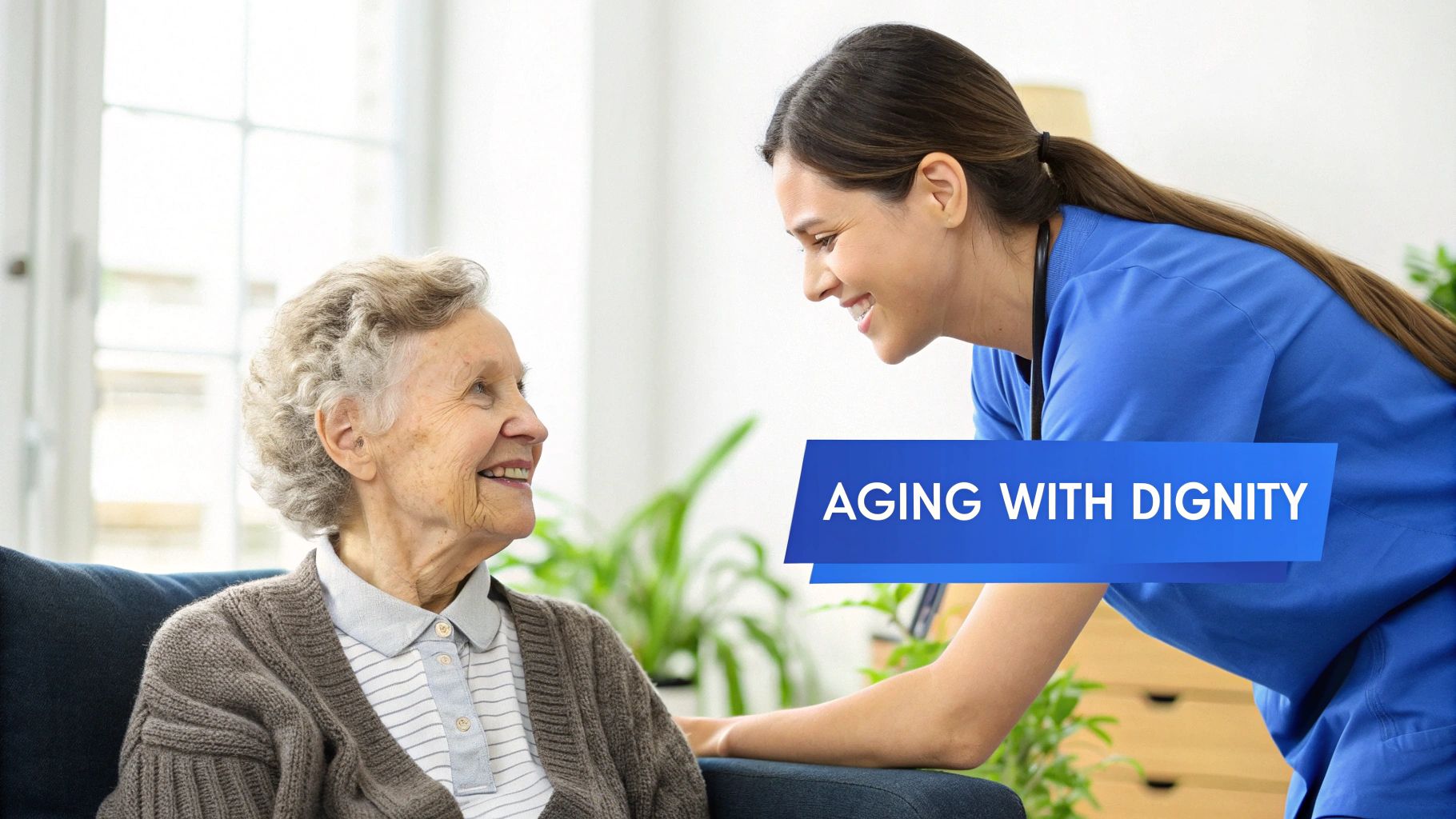 A smiling elderly woman looks at a caring female caregiver in blue scrubs. Text: AGING WITH DIGNITY.