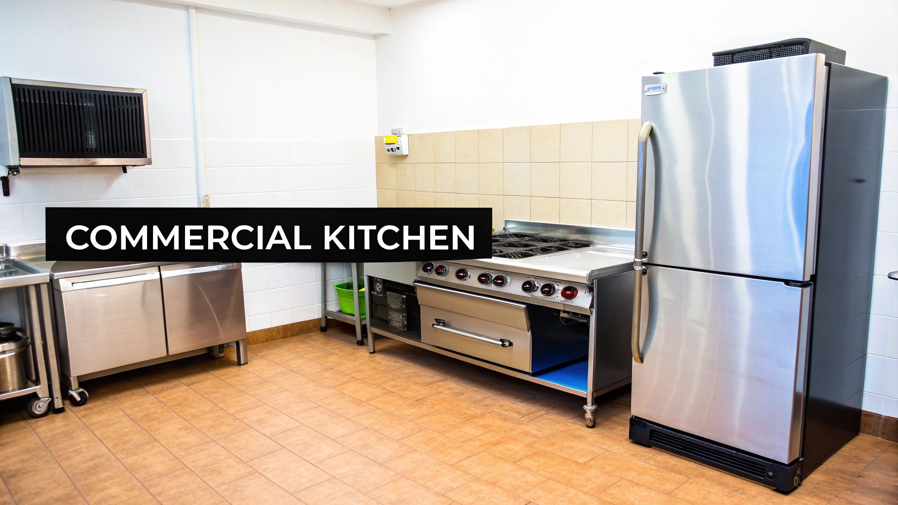 A clean and modern commercial kitchen featuring stainless steel appliances, a stove, sink, and refrigerator.