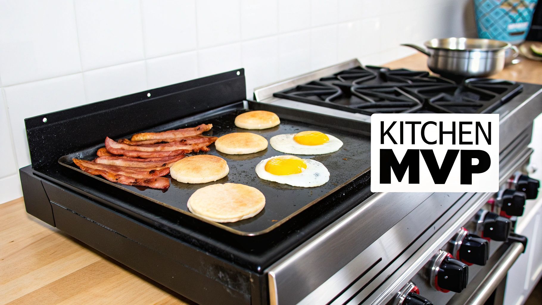Bacon, fried eggs, and English muffins cooking on a black griddle attached to a kitchen range.
