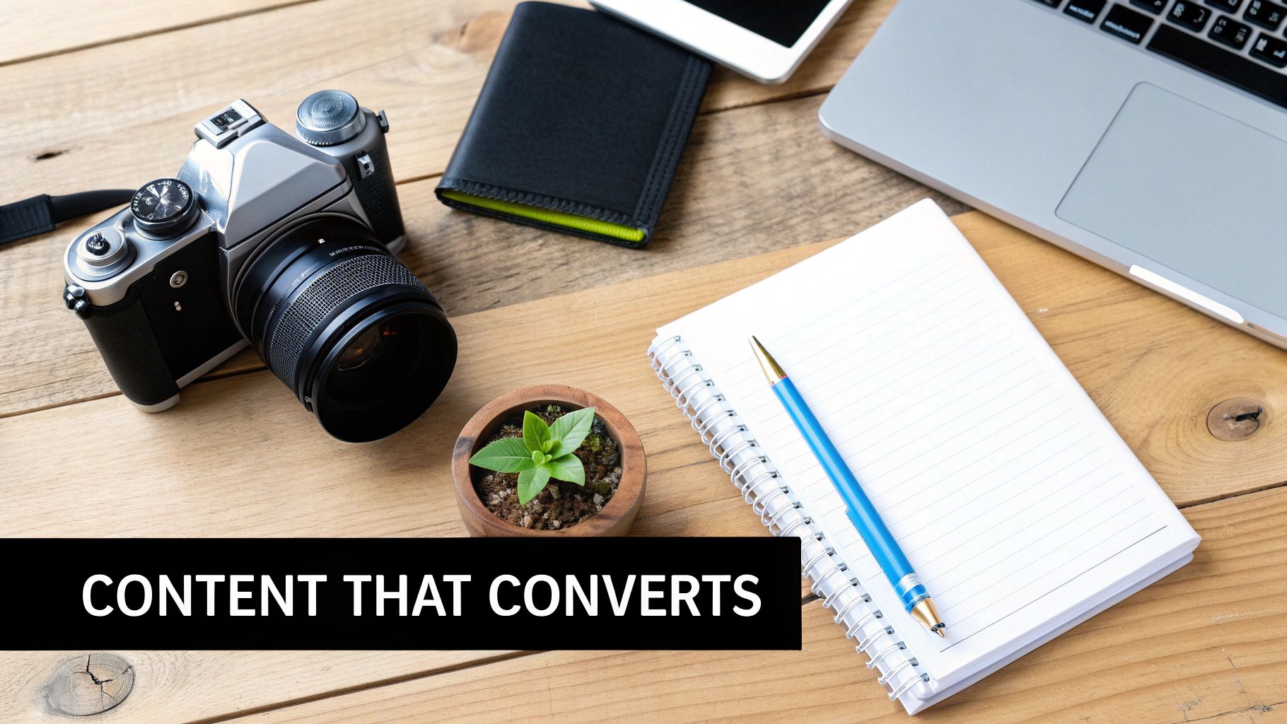 A person writing in a notebook at a desk with a laptop, symbolizing content creation.